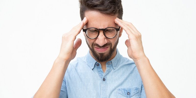 Stressed man suffering from headache